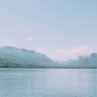 A lake with snowy mountains behind it